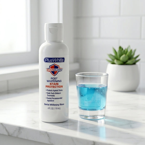 Plus White StainGuard bottle with a glass of blue liquid on a marble countertop.